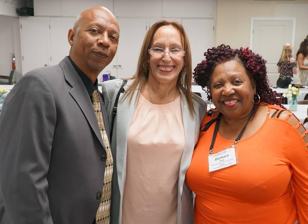 Yvette smiling alongside supporters at a ministry gathering